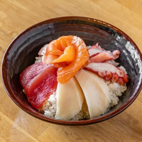Umami Japanese Cuisine's colorful chirashi bowl with salmon, tuna, octopus, and white fish over rice.